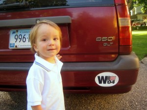 toddler behind SUV